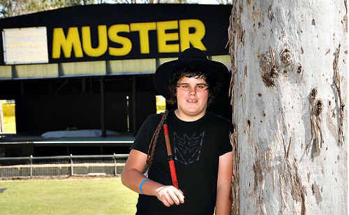 CRACKIN GOOD MUSTER: Whip cracking guru Jamie Law in front of the new yellow Muster sign on Main Stage. The Muster has changed from red to yellow to incorporate new major sponsor Optus’ colours. CRACKIN GOOD MUSTER: Whip cracking guru Jamie Law in front of the new yellow Muster sign on Main Stage. The Muster has changed from red to yellow to incorporate new major sponsor Optus’ colours.